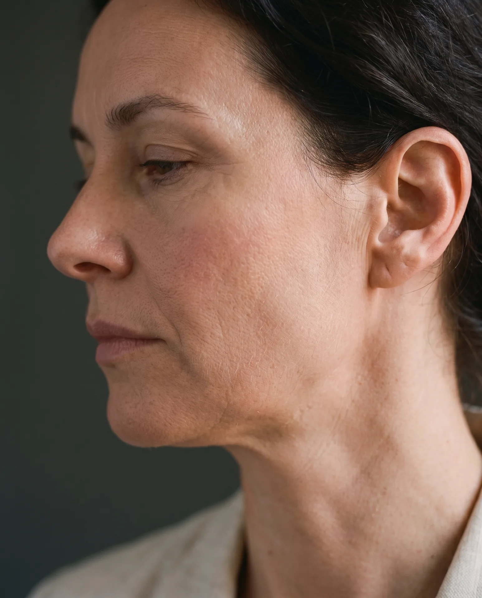Portrait detail of Elena Orlova in soft window light, natural skin texture visible
